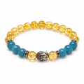 8mm citrine and aquamarine stretch bracelet with golden yellow and blue beads, silver-tone spacers and Buddha head on white