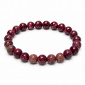 8mm Eudialyte stretch bracelet with burgundy red round beads and dark mineral patterns on white