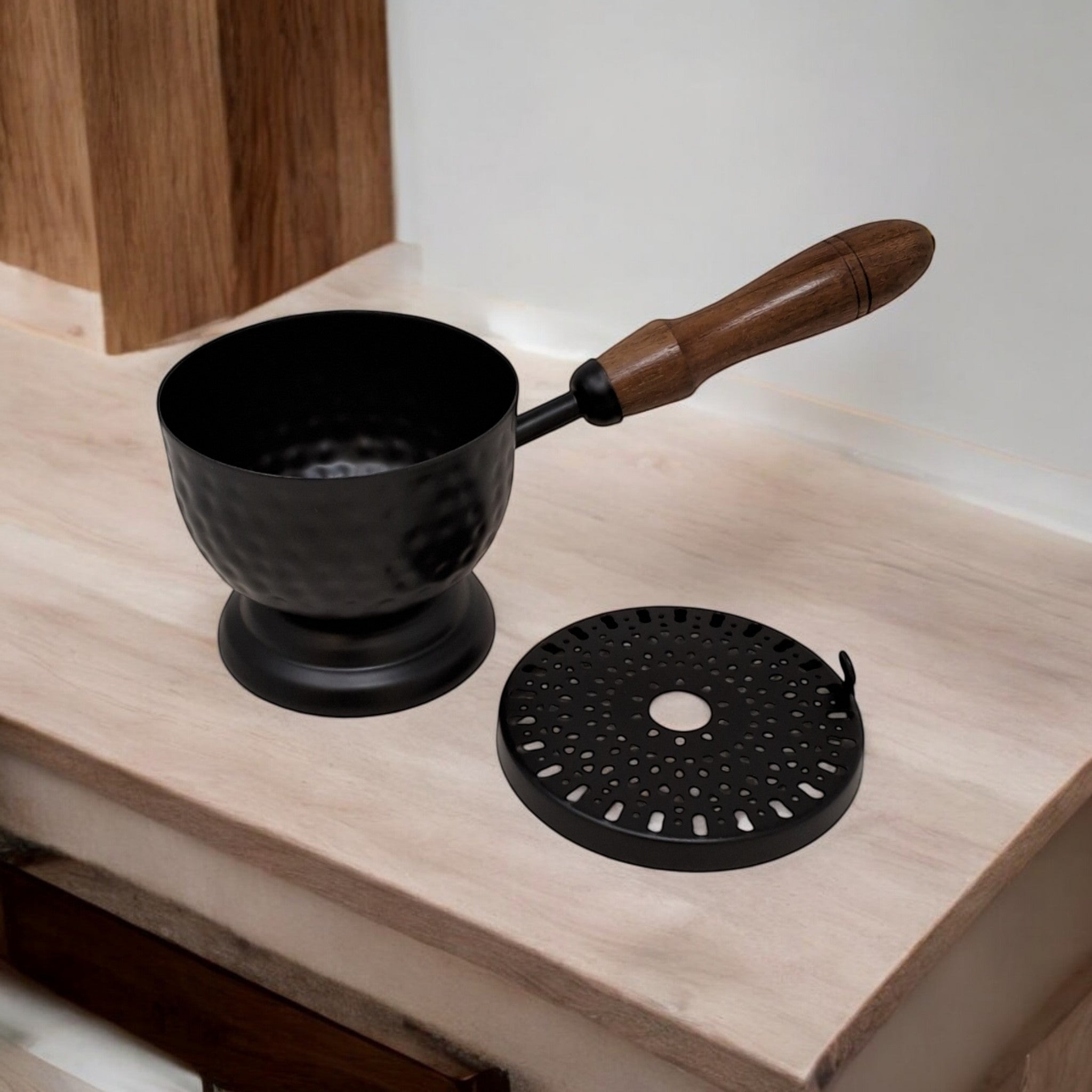 Crystal Fairy Patch 9-inch matte black iron cauldron incense burner with hammered texture, wooden handle, and perforated lid.