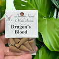 Crystal Fairy Patch Dragon's Blood premium hand made incense cones in a clear plastic bag against a green leaf background