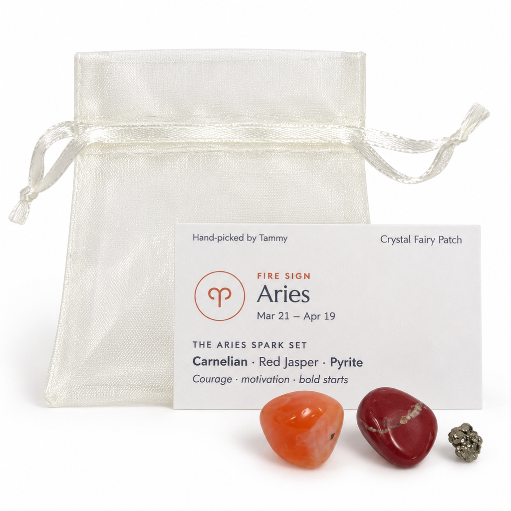 Aries Spark crystal set with Carnelian, Red Jasper and Pyrite beside zodiac card and ivory gift bag