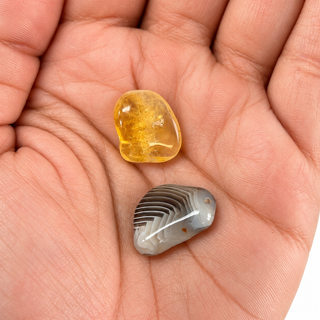 Citrine and Banded Agate shown close up in an open palm