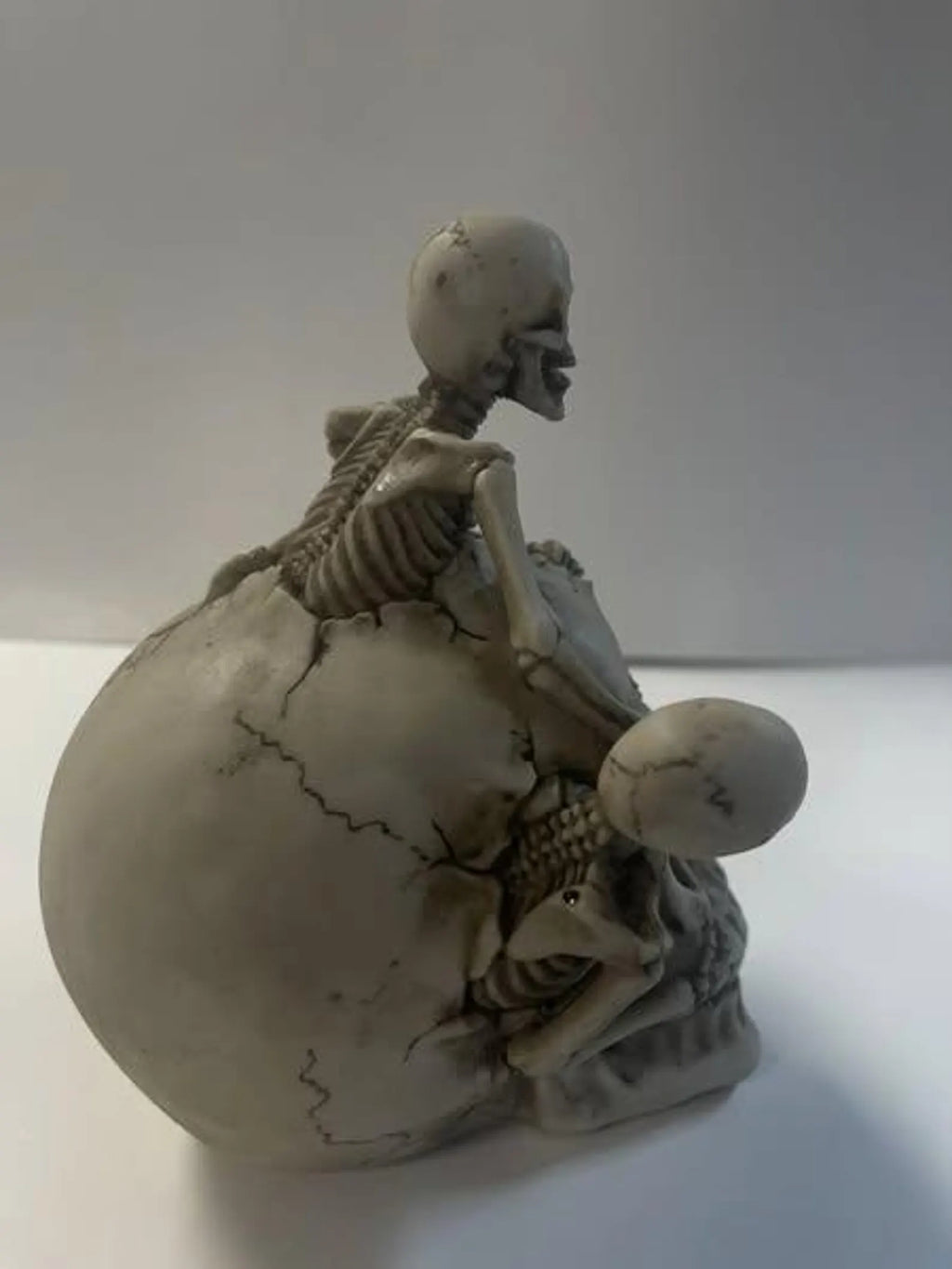 Skull with 3 Climbing Skeletons Statue