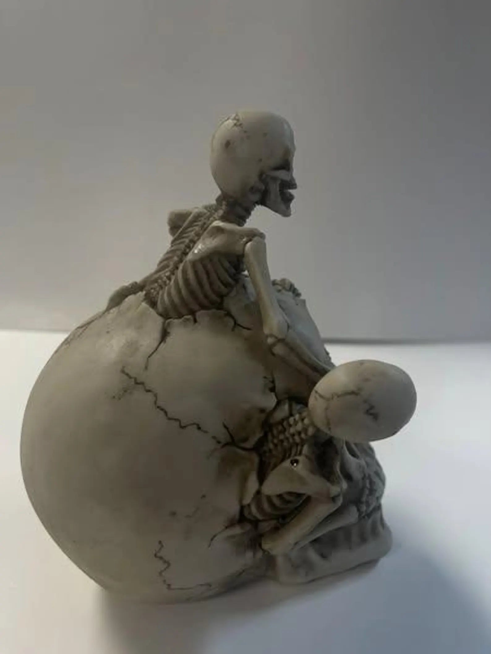 Skull with 3 Climbing Skeletons Statue