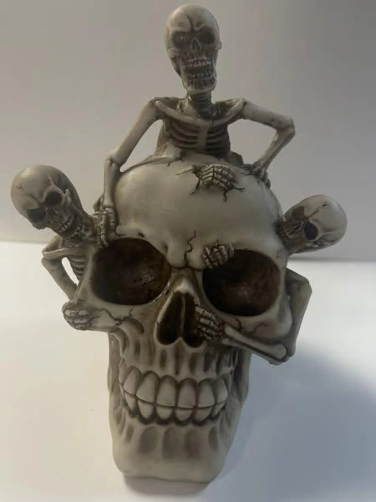 Skull with 3 Climbing Skeletons Statue