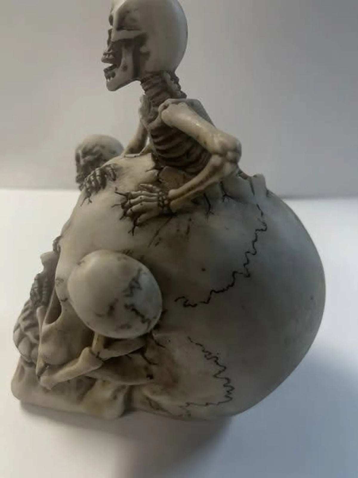 Skull with 3 Climbing Skeletons Statue